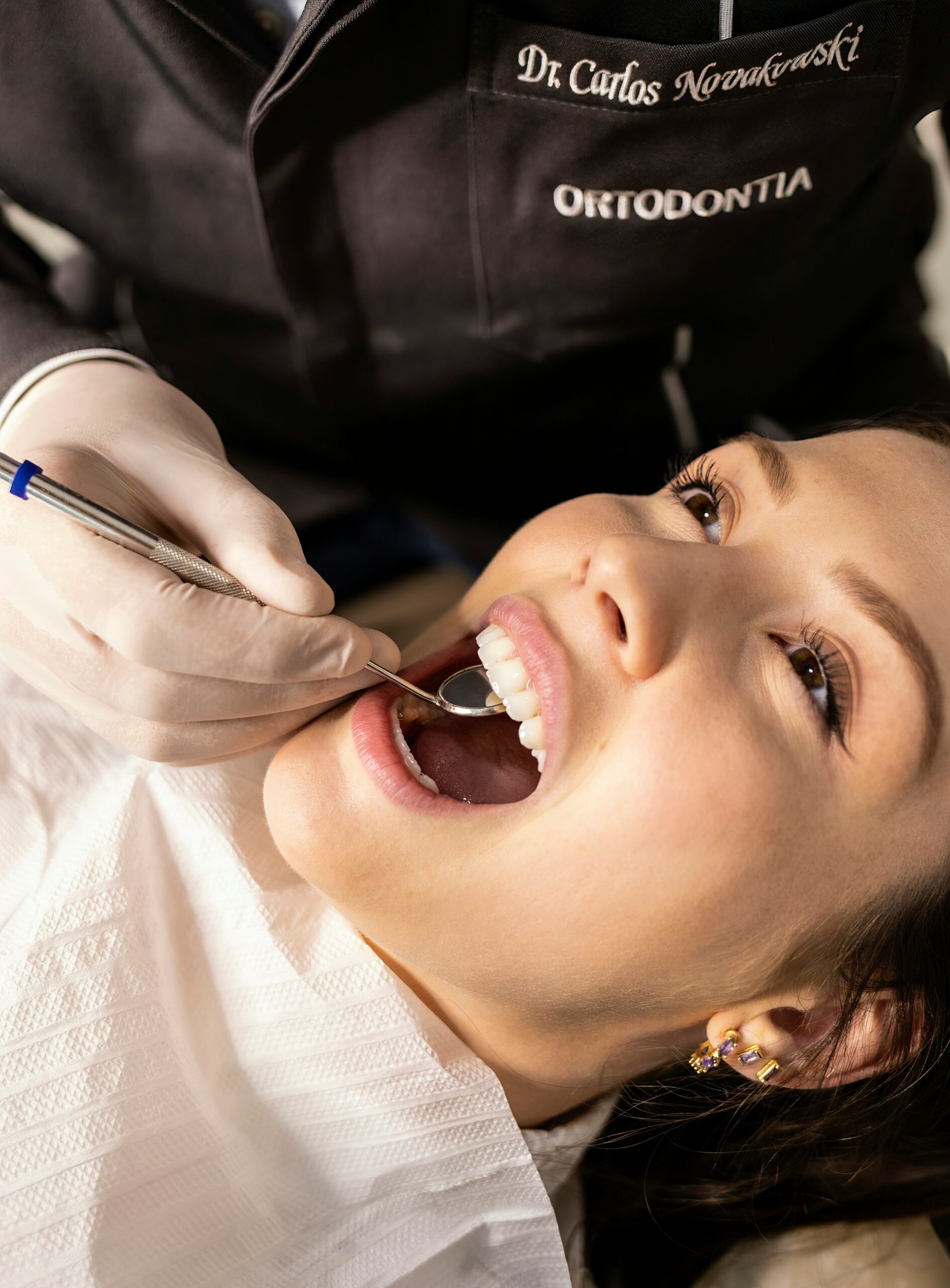 Dentist examining patient's teeth during a dental checkup, highlighting family dentistry services at Alpha Dental in Universal City, TX.
